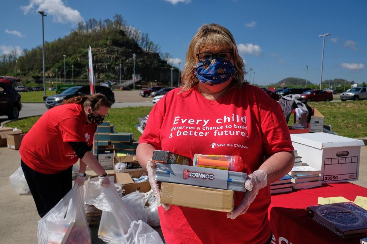 Image of volunteers packing care kits for Save the Children