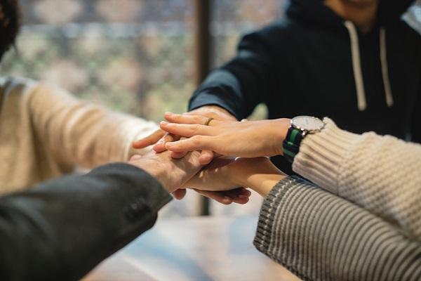 Five people holding each other hands